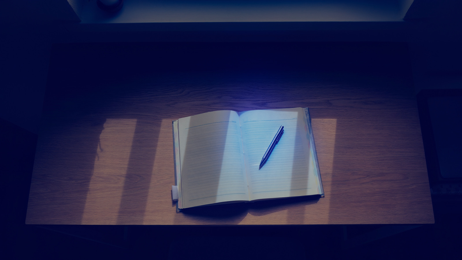 Open ledger on a navy desk representing the state tax conformity research process for Section 179